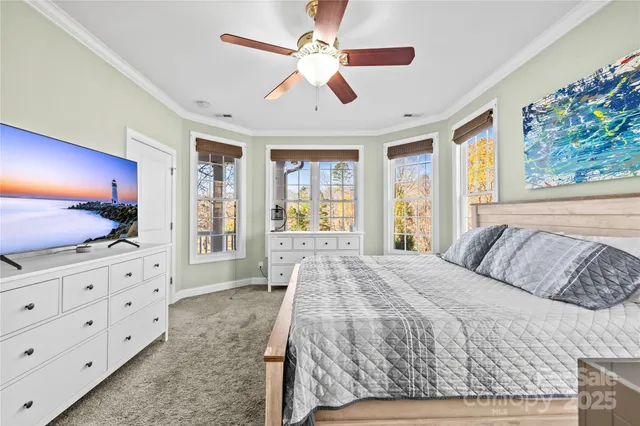 a bedroom with a bed dresser and a flat tv screen