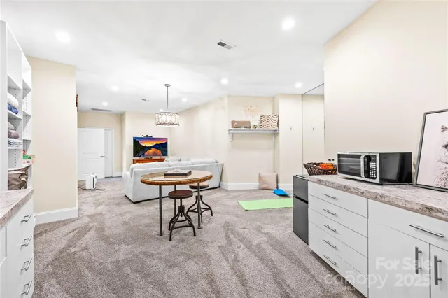 a kitchen with a sink cabinets and wooden floor