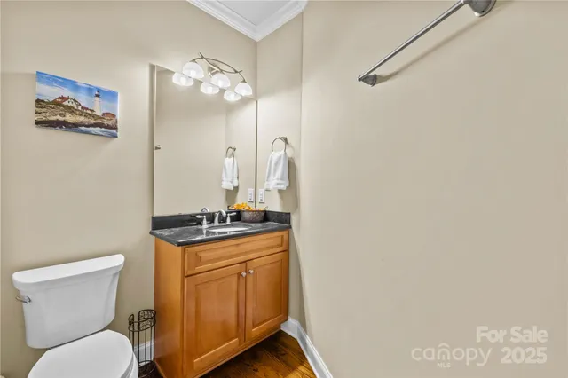 a bathroom with a granite countertop toilet a sink and a mirror