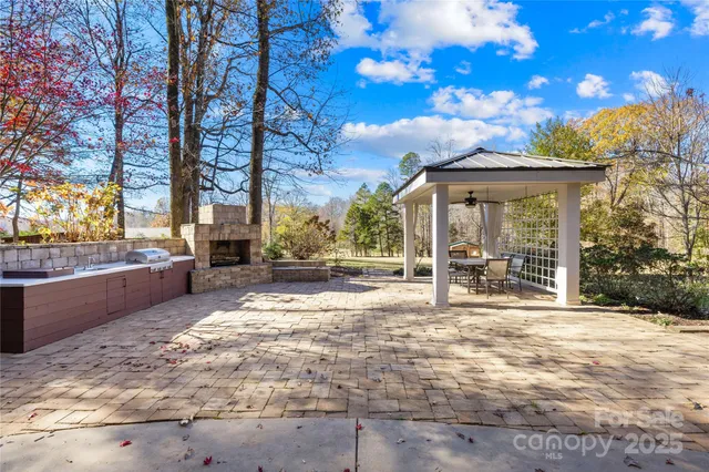 a view of a patio with table and chairs with wooden fence