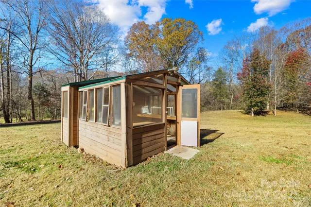 a view of house with backyard and trees