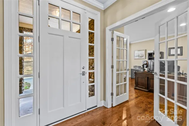 a view of a kitchen with an entryway and livingroom with furniture