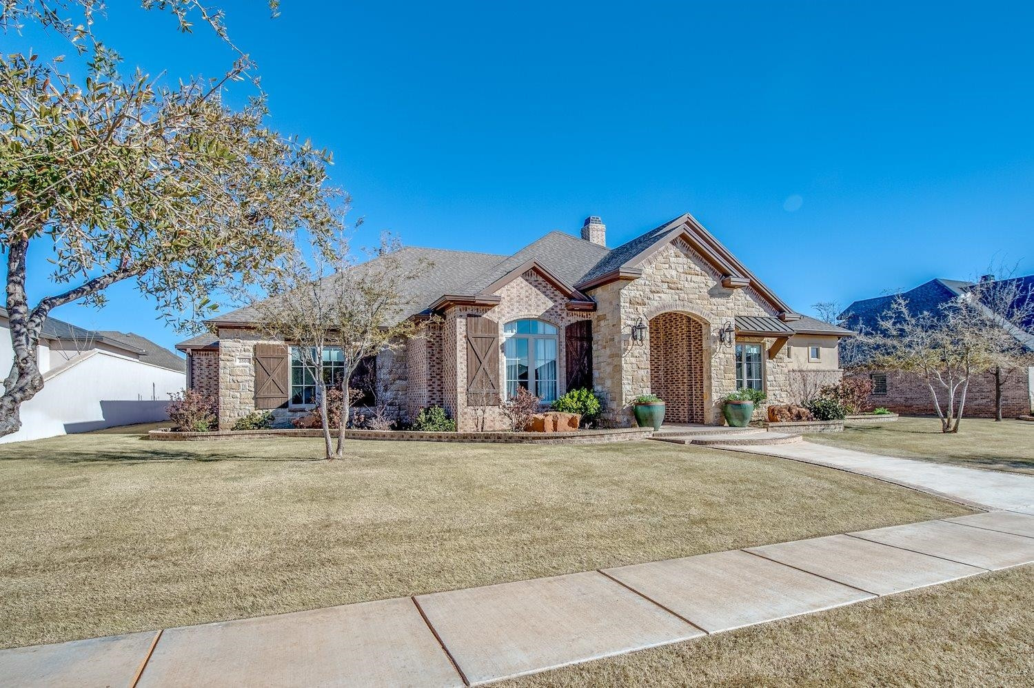 3806 111th Street Lubbock, TX 79423 - Photo 3 of 10 a view of a house with a yard and large tree