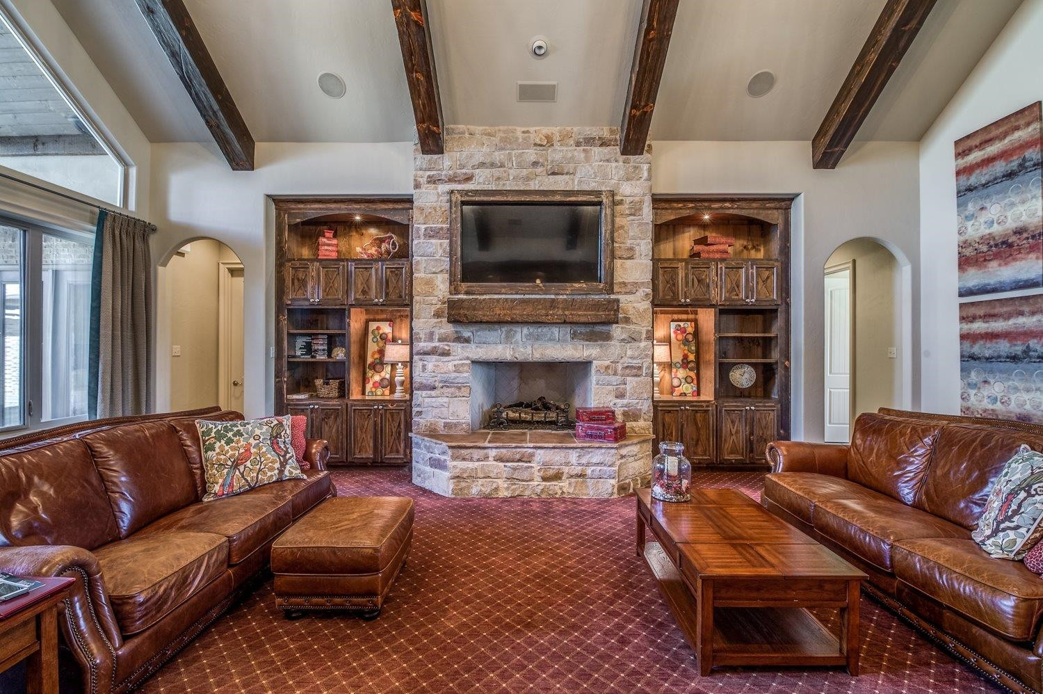 3806 111th Street Lubbock, TX 79423 - Photo 9 of 10 a living room with furniture a flat screen tv and a fireplace
