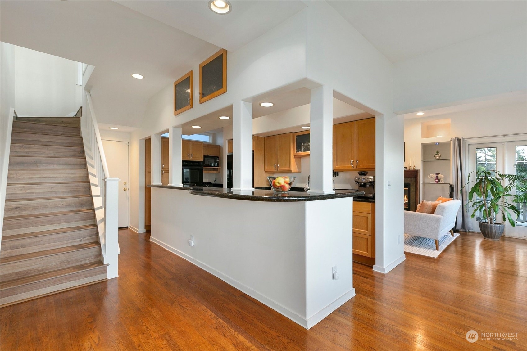 3205 South Judkins Street Seattle, WA 98144 - Photo 22 of 40 a view of a living room with kitchen view and wooden floor