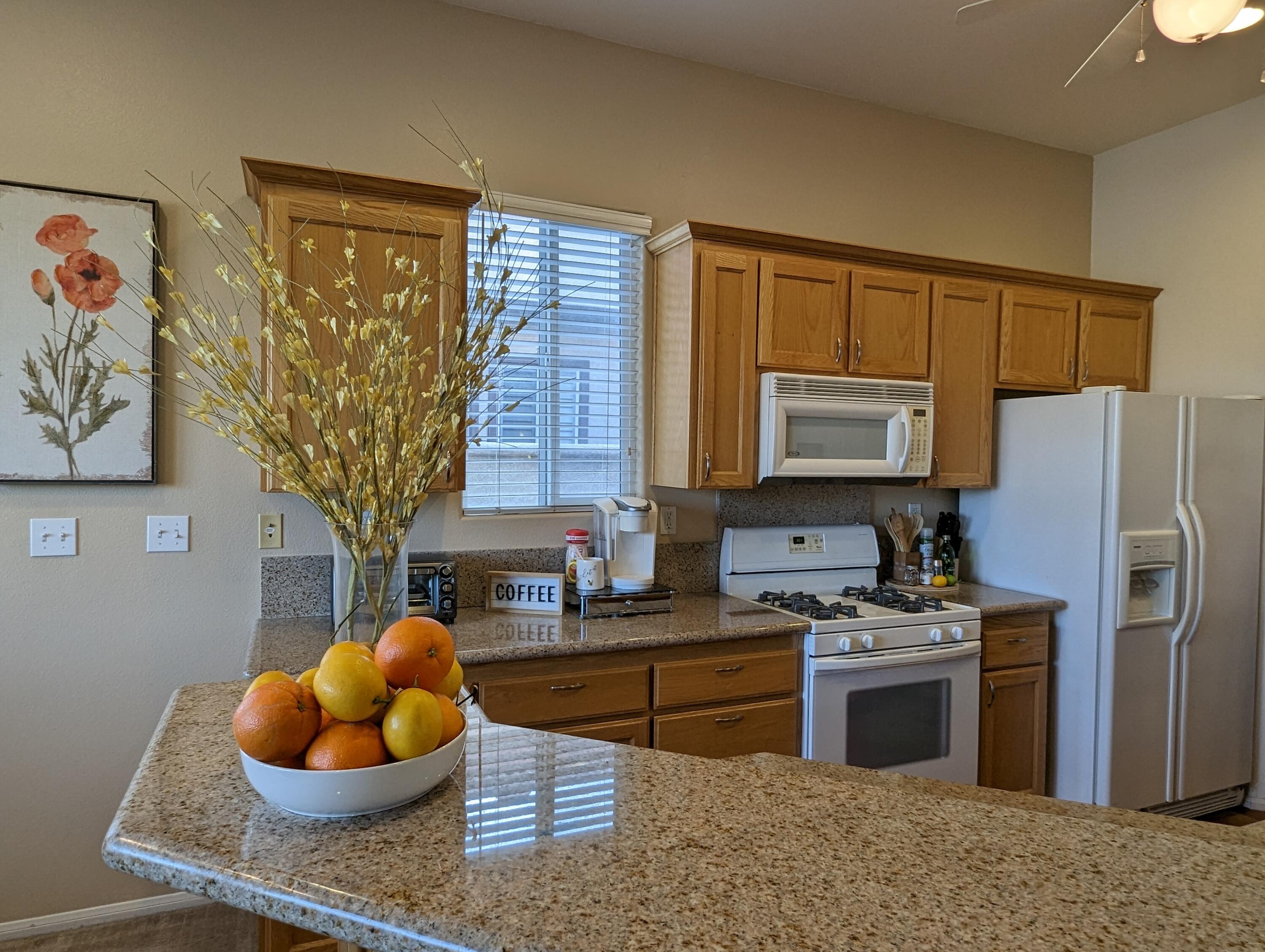 49544 Wayne Street Indio, CA 92201 - Photo 16 of 69 a kitchen with stainless steel appliances granite countertop a sink a stove and a refrigerator