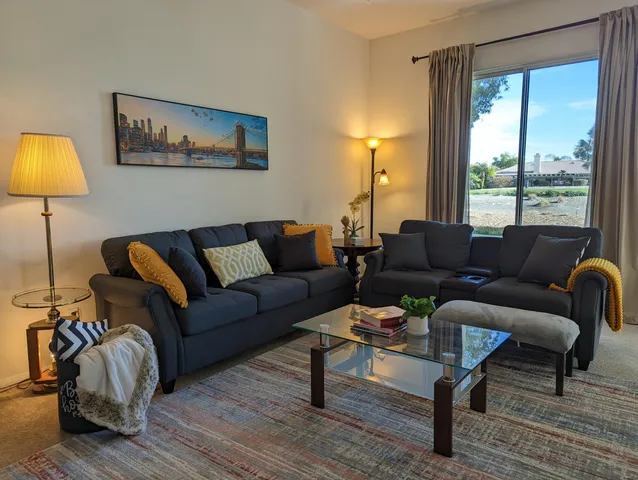 a living room with furniture and a fireplace