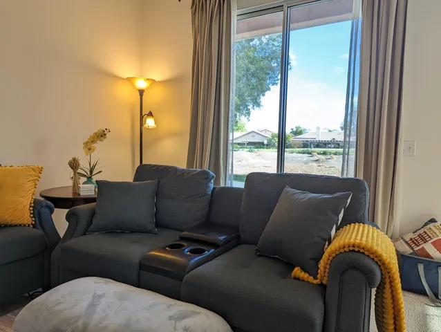 a bed sitting in a bedroom next to a window with two lamps