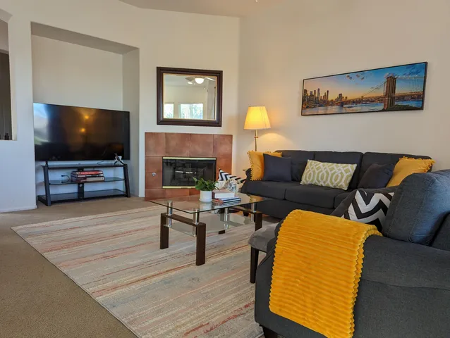 a bed sitting in a bedroom next to a window with lamp