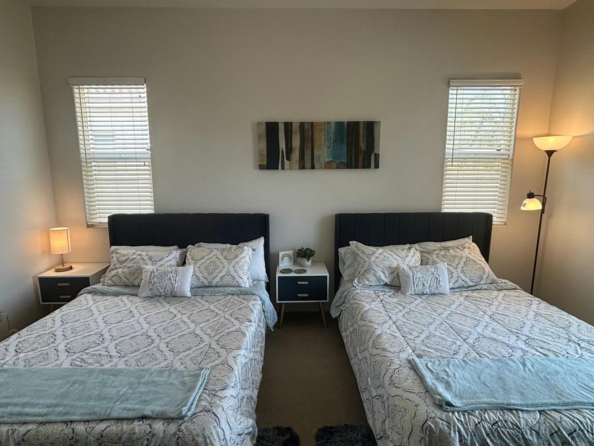 49544 Wayne Street Indio, CA 92201 - Photo 38 of 69 a bed sitting in a bedroom next to a window with two lamps