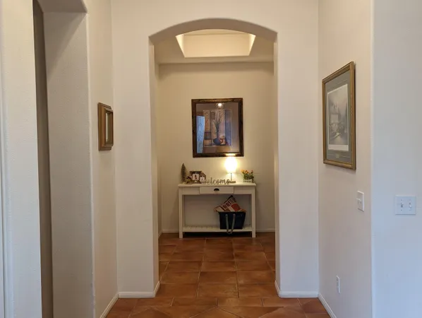 a view of hallway with sink and mirror