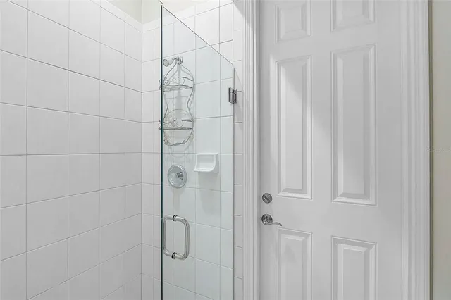 a spacious bathroom with a granite countertop sink a mirror and shower