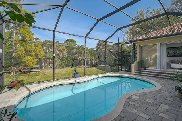 an aerial view of a house with yard swimming pool and outdoor seating