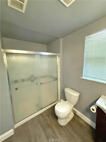 a bathroom with a toilet and a shower
