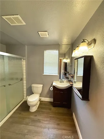a bathroom with a sink mirror vanity and toilet