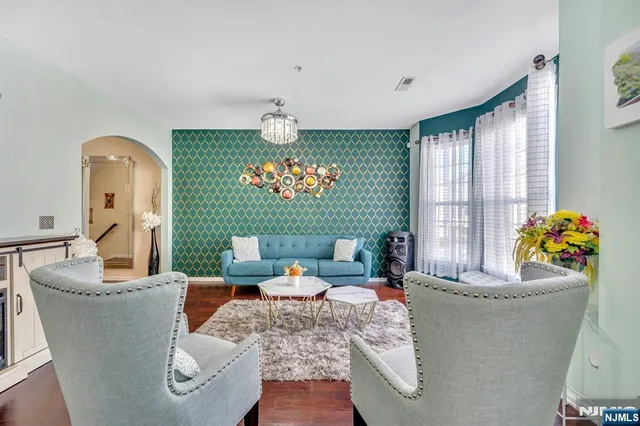 a living room with fireplace furniture and a large window