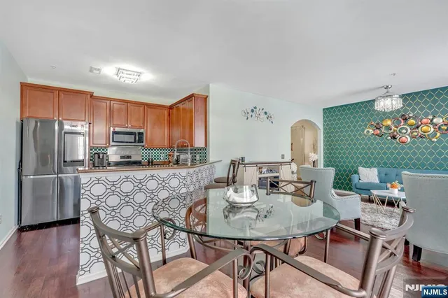 a view of a dining room with furniture a chandelier and wooden floor
