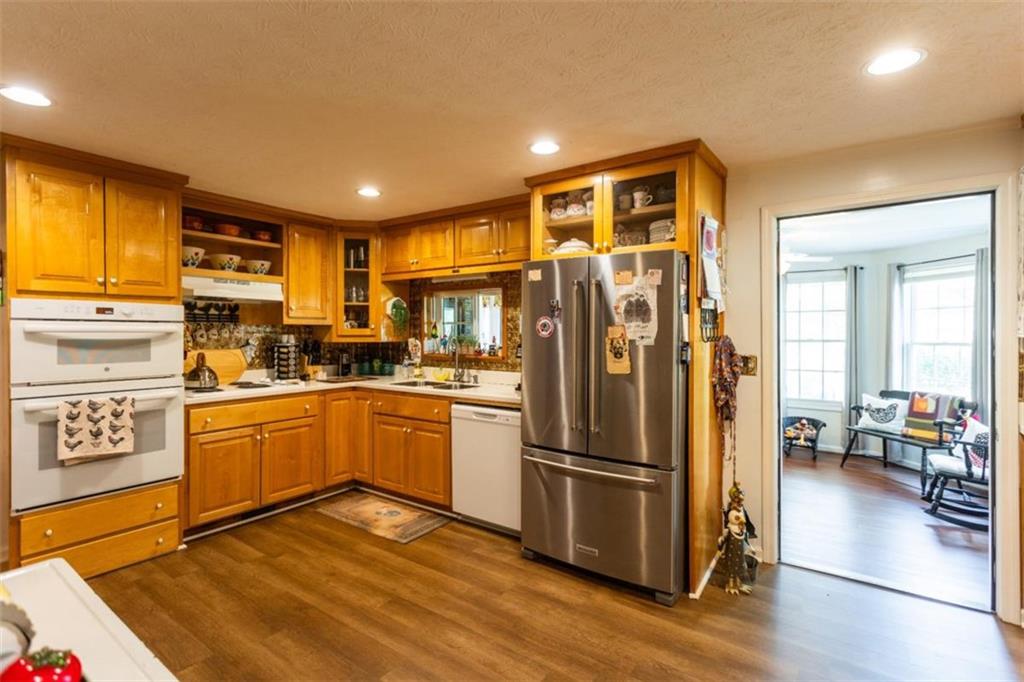 116 East Fulton Street Newborn, GA 30056 - Photo 26 of 74 a kitchen with stainless steel appliances granite countertop a refrigerator a stove top oven a sink and island