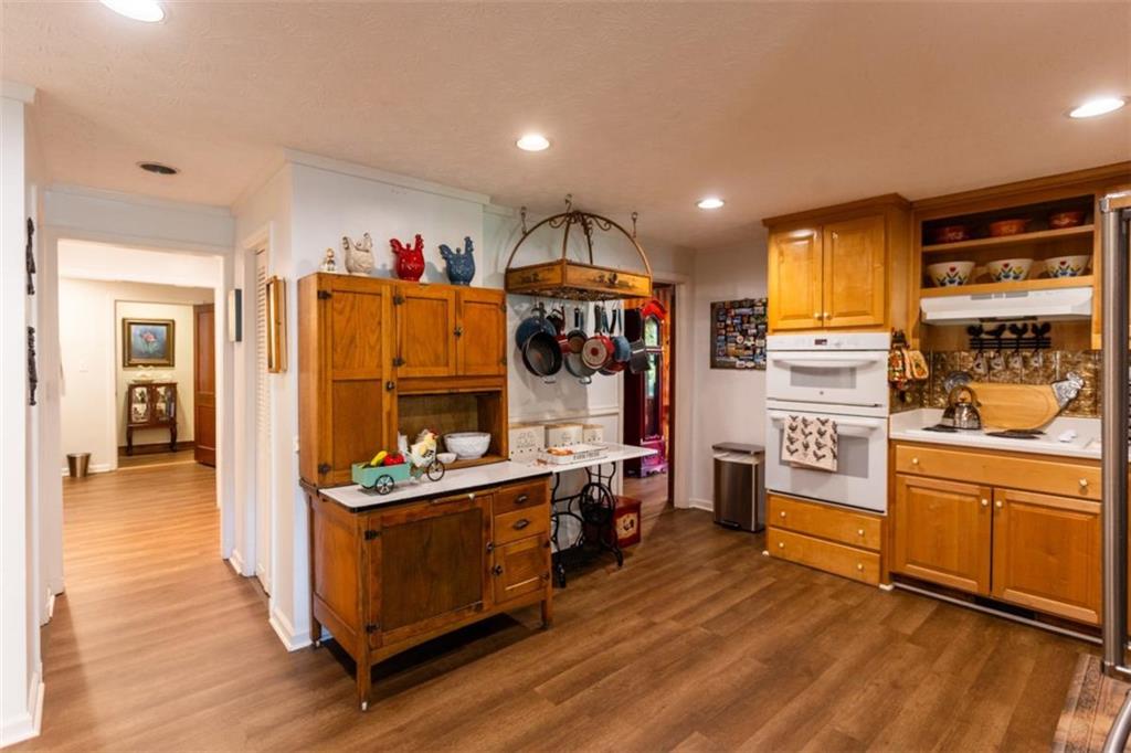 116 East Fulton Street Newborn, GA 30056 - Photo 27 of 74 a kitchen that has a lot of cabinets a sink and appliances in it