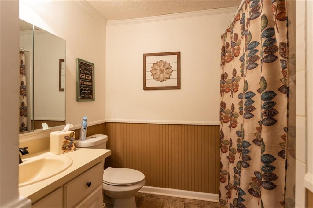 116 East Fulton Street Newborn, GA 30056 - Photo 40 of 74 a bathroom with a sink a toilet and shower curtain