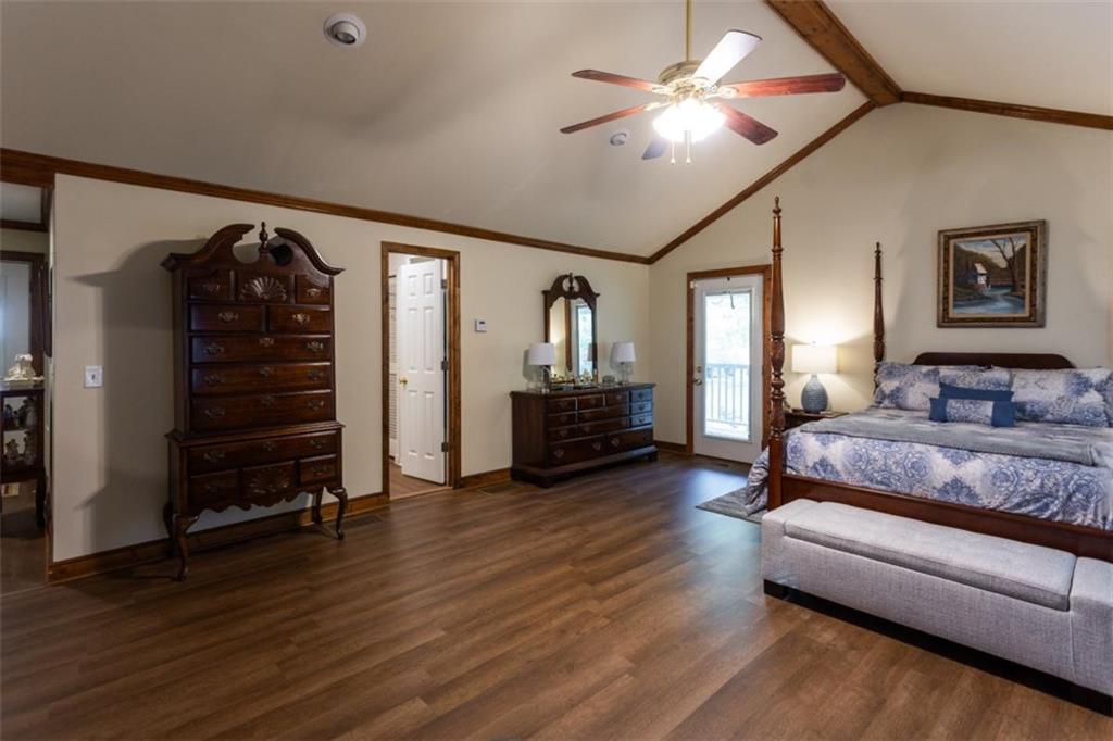 116 East Fulton Street Newborn, GA 30056 - Photo 46 of 74 a spacious bedroom with a bed and wooden floor