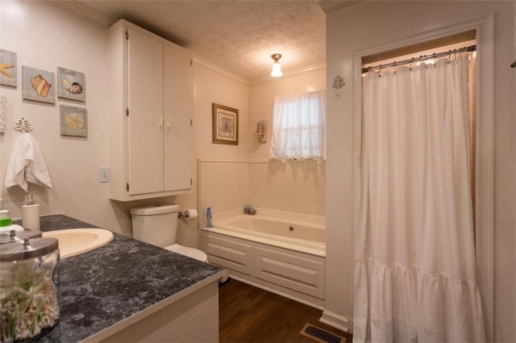 116 East Fulton Street Newborn, GA 30056 - Photo 48 of 74 a bathroom with a granite countertop sink and a mirror