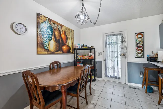 a dining room with furniture and window