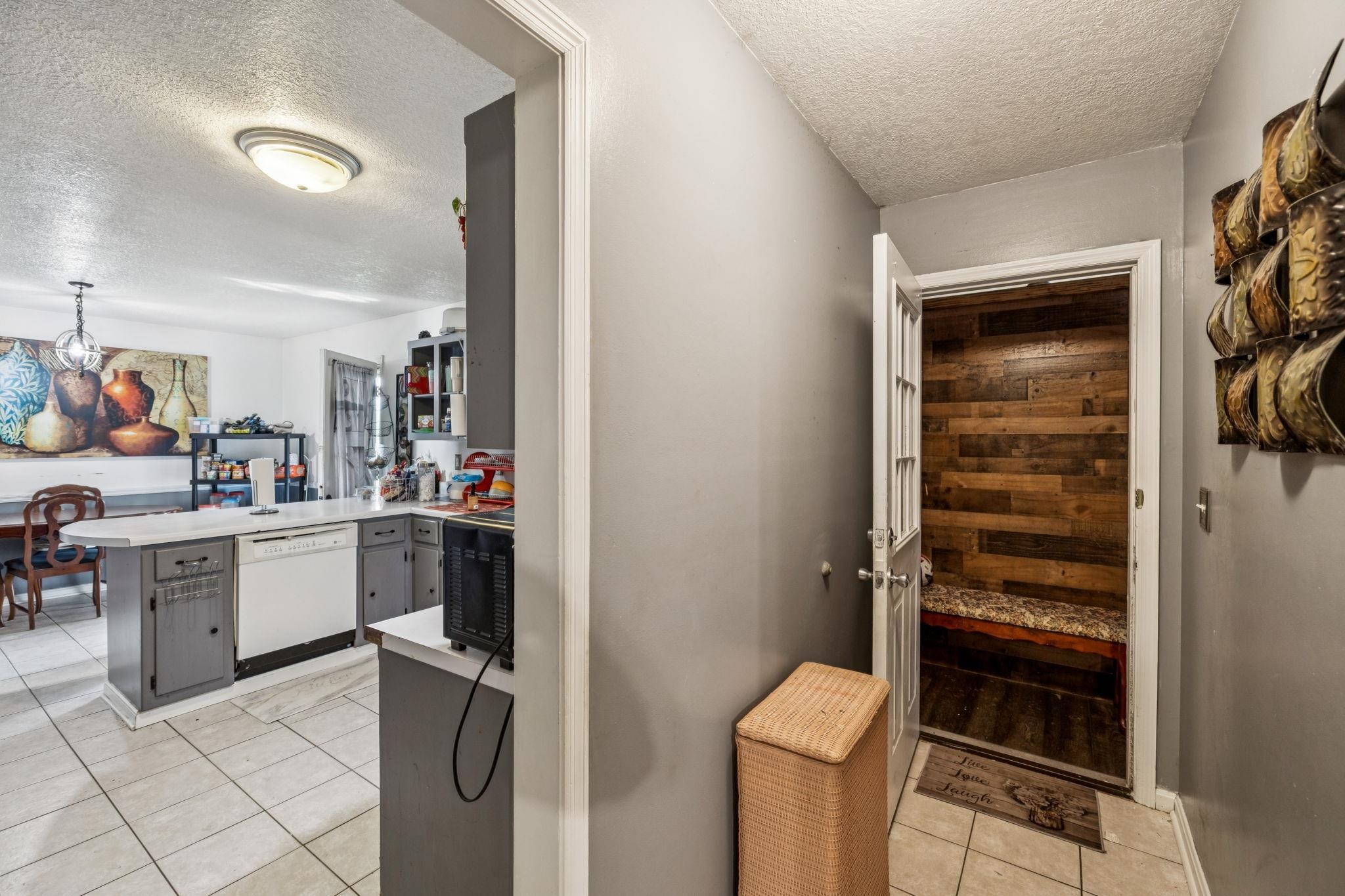 537 Isbell Lane Decherd, TN 37324 - Photo 16 of 40 a kitchen with a refrigerator and white cabinets
