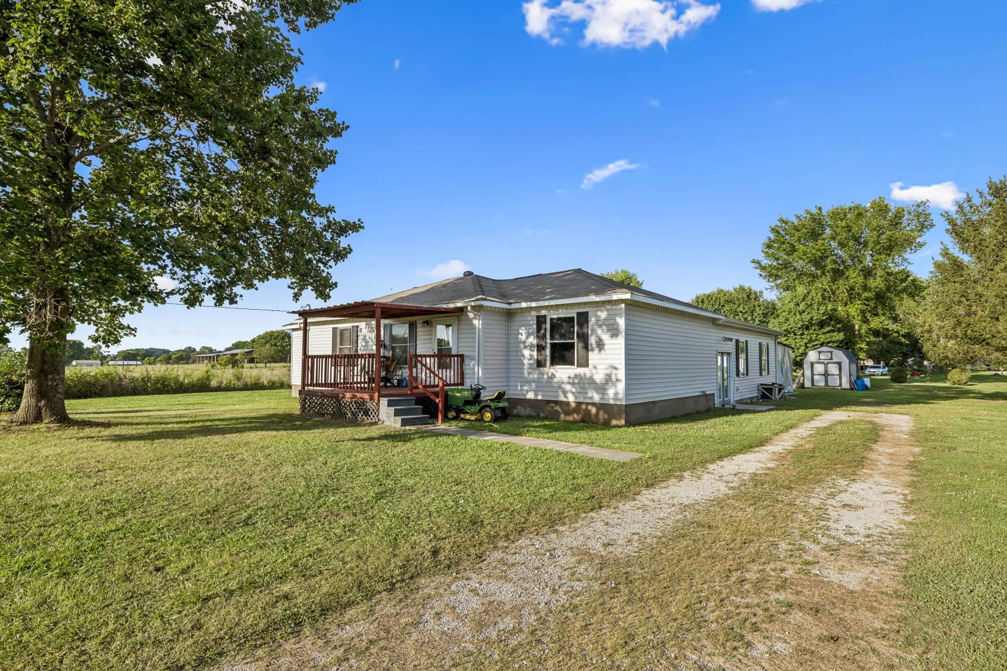 537 Isbell Lane Decherd, TN 37324 - Photo 2 of 40 a view of a house with a big yard and large trees