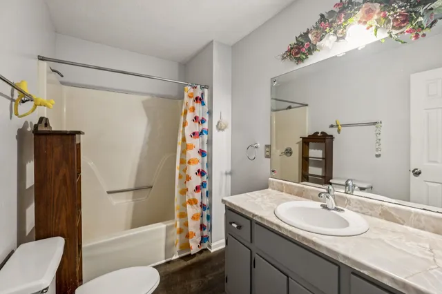 a bathroom with a sink toilet and shower