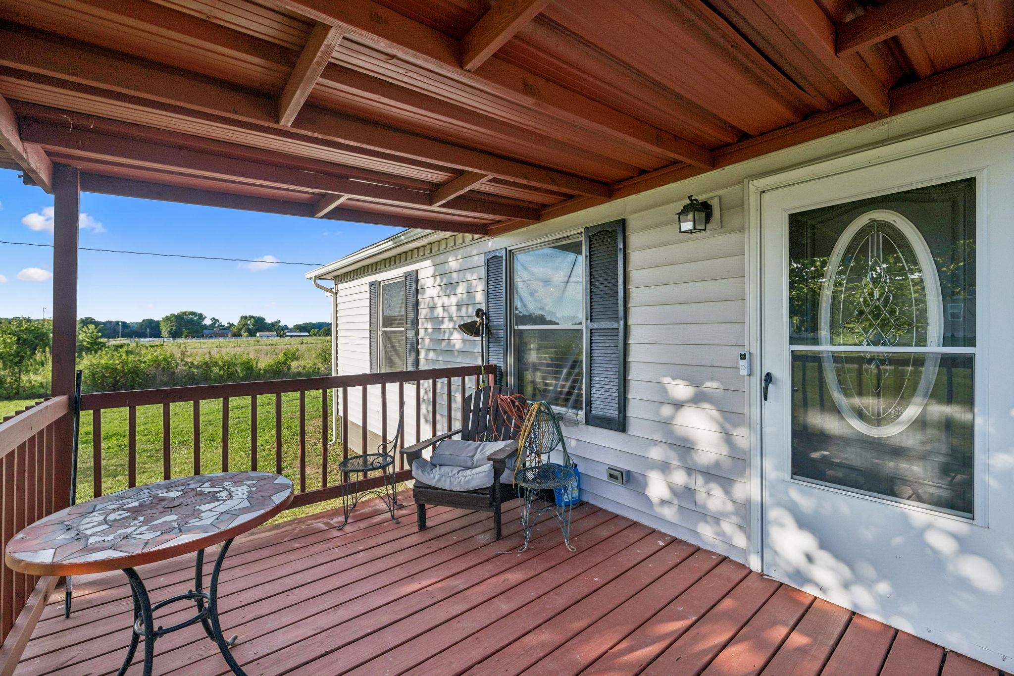 537 Isbell Lane Decherd, TN 37324 - Photo 3 of 40 a view of a deck with chair and wooden floor