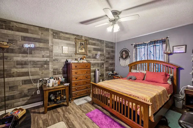 a bedroom with a bed next to a window