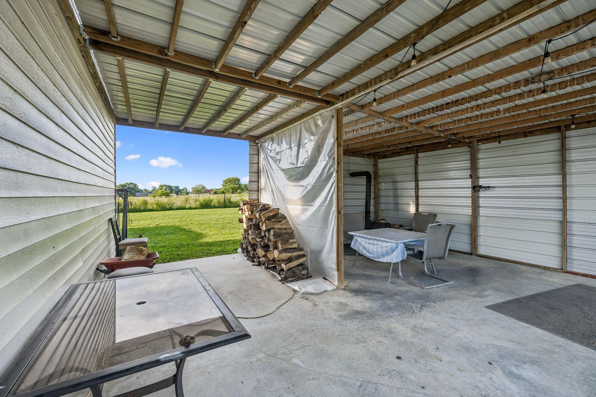 537 Isbell Lane Decherd, TN 37324 - Photo 33 of 40 a view of a patio with a table and chairs and a barbeque