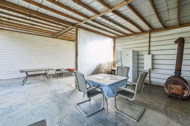 a view of a patio with table and chairs with wooden floor and fence