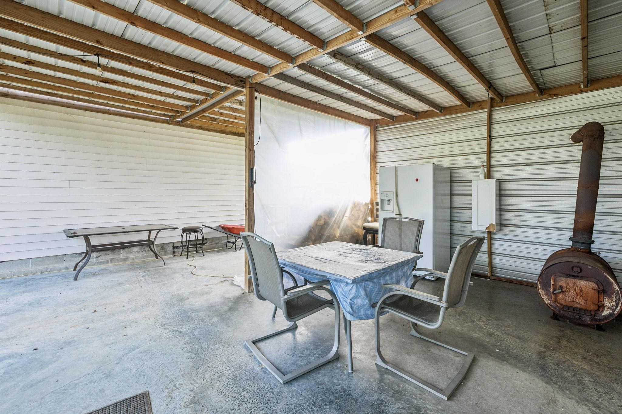 537 Isbell Lane Decherd, TN 37324 - Photo 34 of 40 a view of a patio with table and chairs with wooden floor and fence