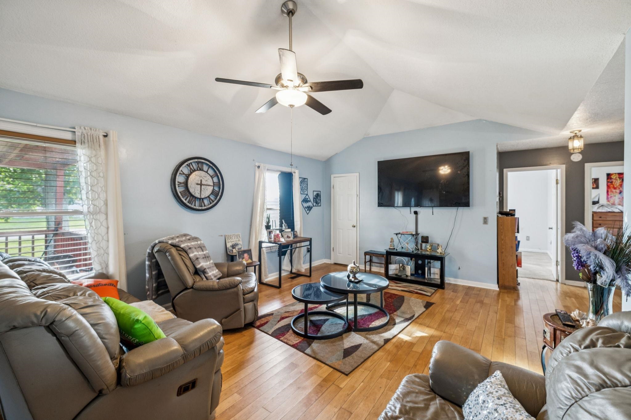 537 Isbell Lane Decherd, TN 37324 - Photo 8 of 40 a living room with furniture a flat screen tv and a large window