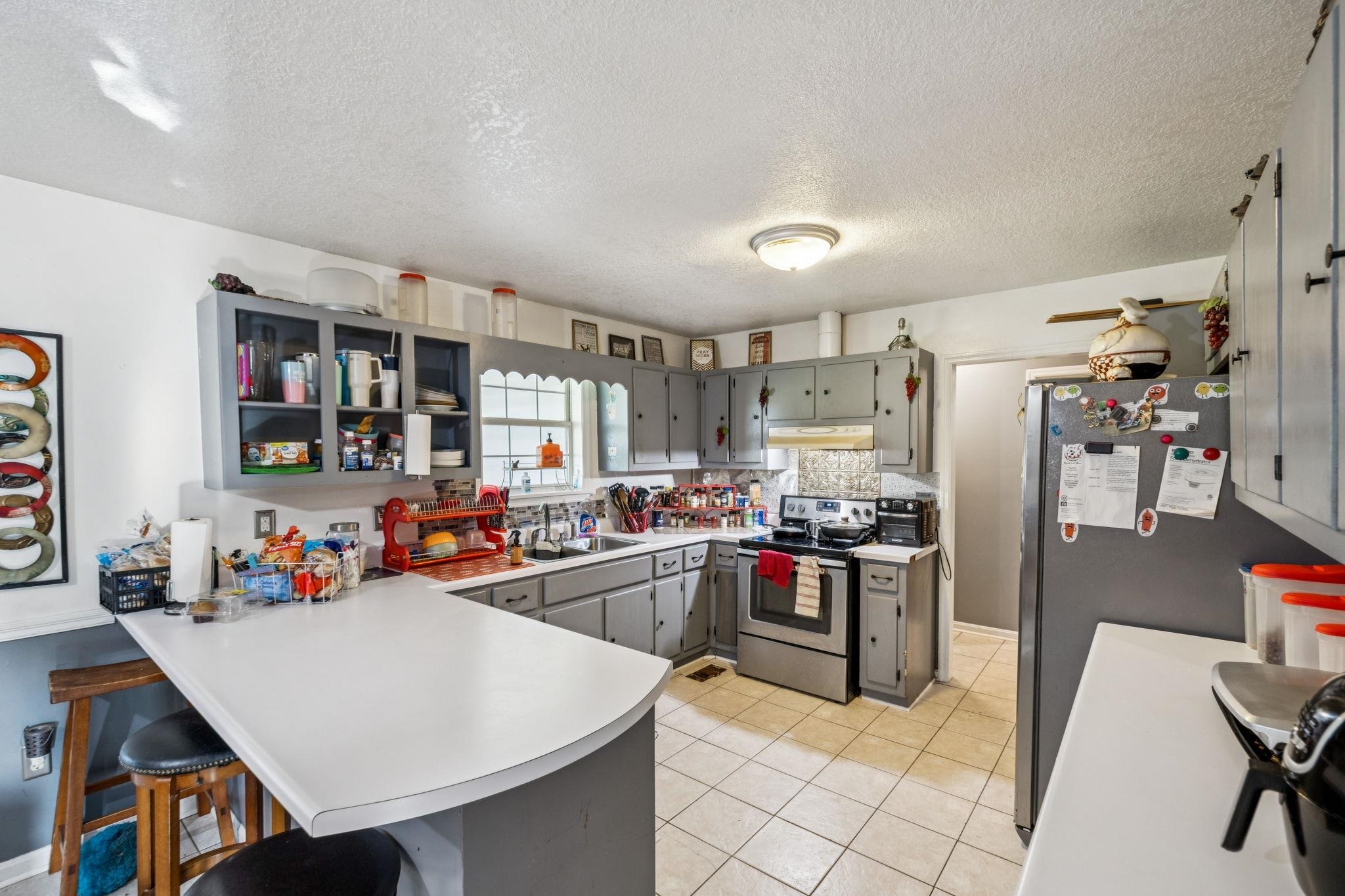 537 Isbell Lane Decherd, TN 37324 - Photo 10 of 40 a kitchen with stainless steel appliances a stove a sink dishwasher and a refrigerator