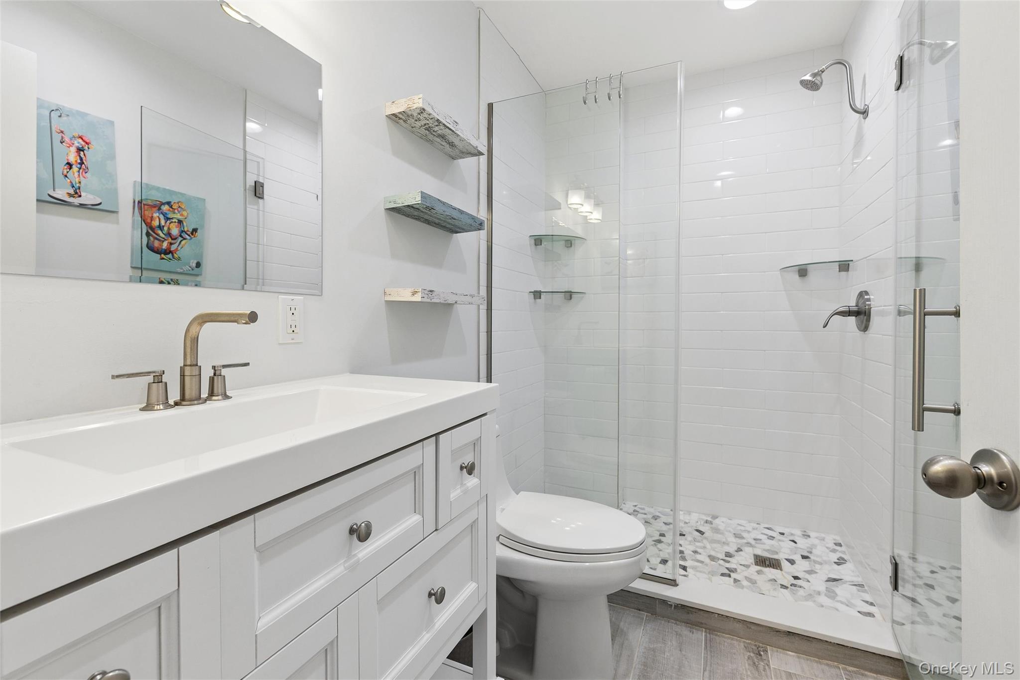 131 Lewis Road East Quogue, NY 11942 - Photo 11 of 25 a bathroom with a sink a toilet and shower