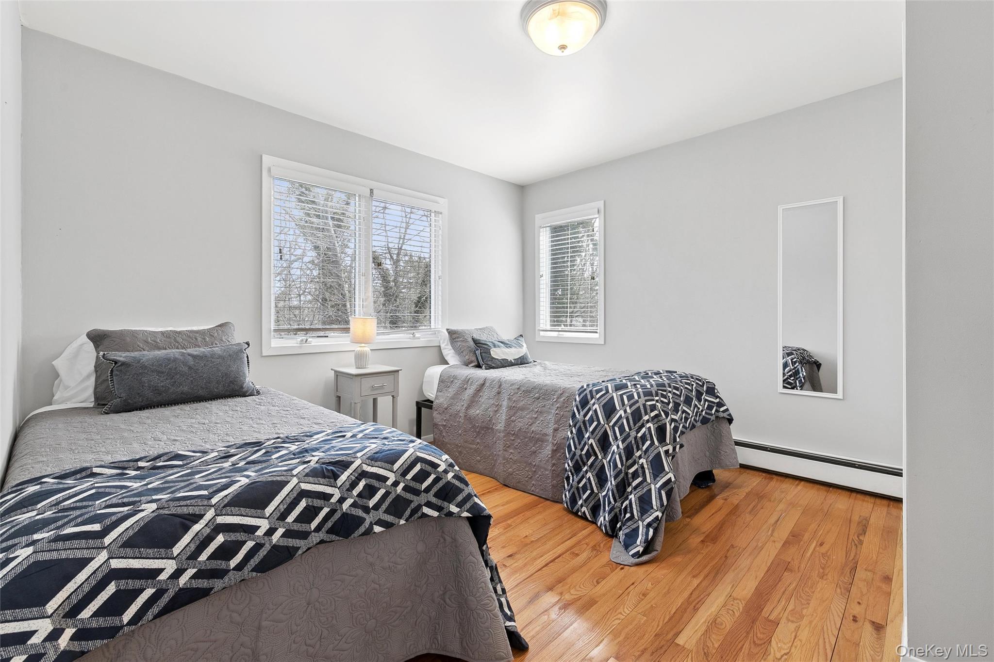 131 Lewis Road East Quogue, NY 11942 - Photo 12 of 25 a bedroom with two bed and a window