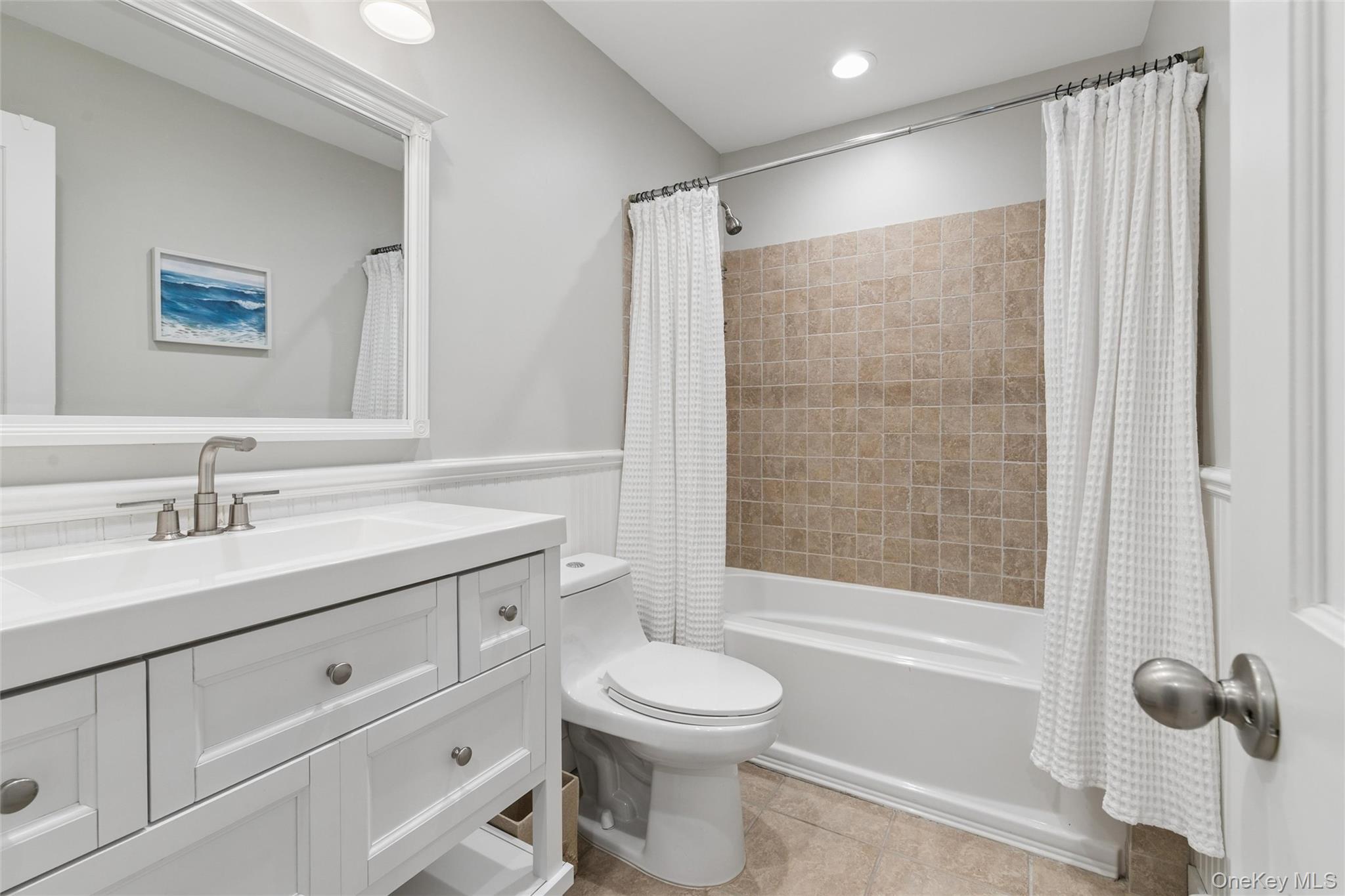 131 Lewis Road East Quogue, NY 11942 - Photo 14 of 25 a bathroom with a toilet sink a mirror and shower