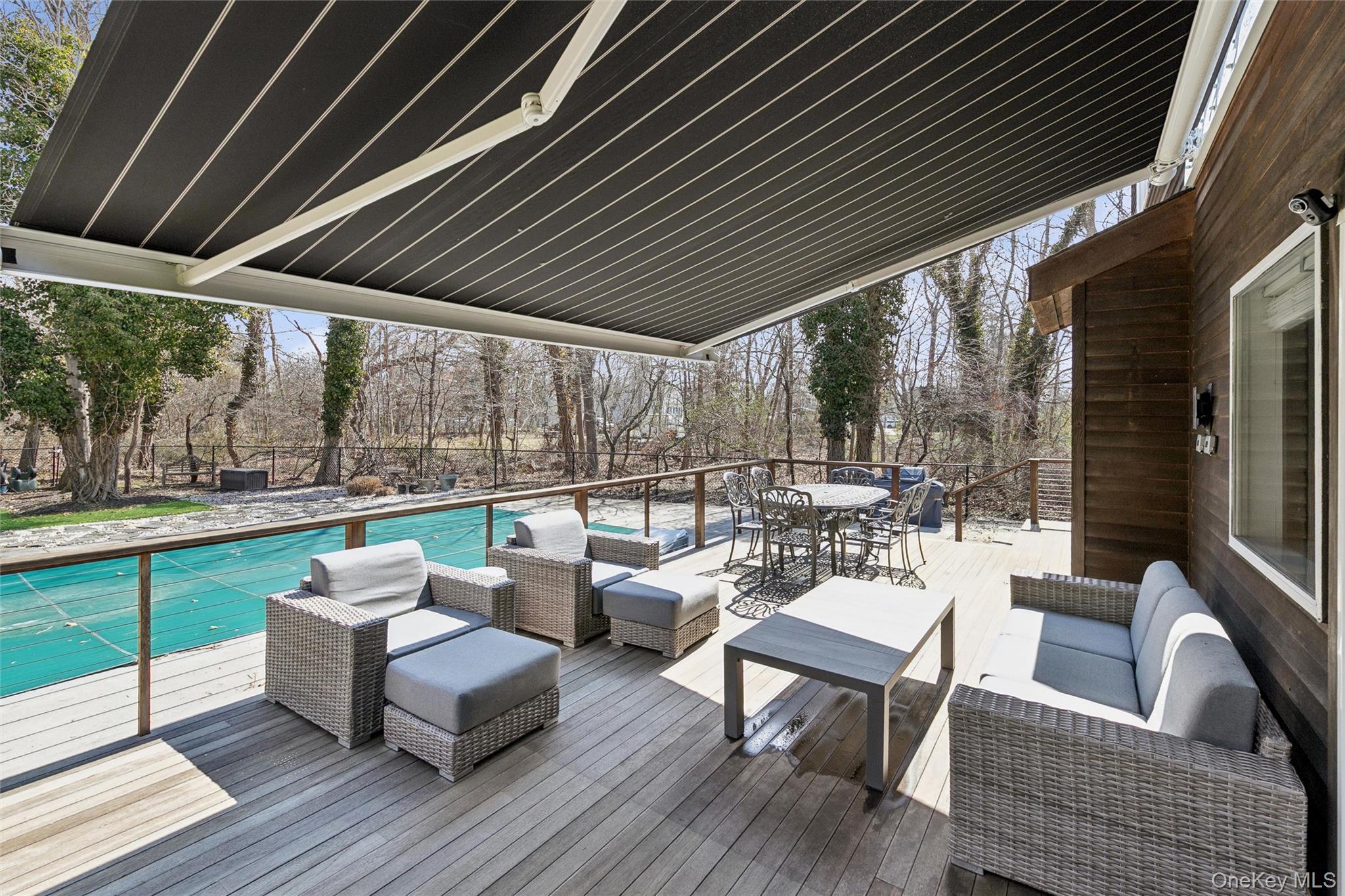 131 Lewis Road East Quogue, NY 11942 - Photo 23 of 25 a patio with patio couch and wooden floor