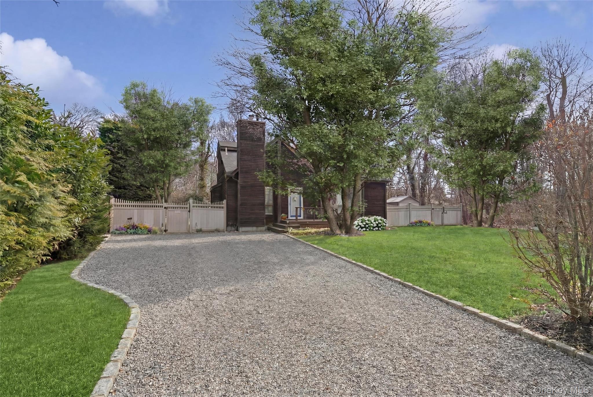 131 Lewis Road East Quogue, NY 11942 - Photo 3 of 25 a pathway of a house with a yard