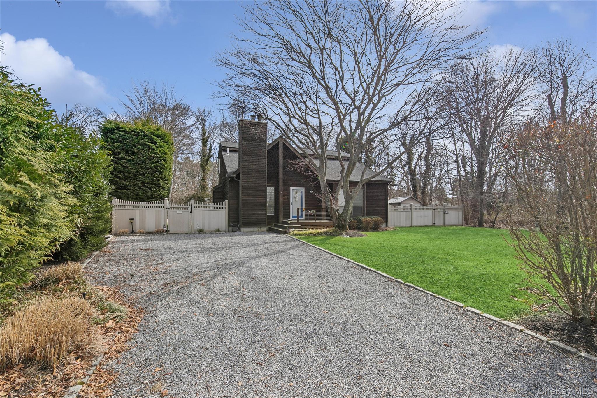 131 Lewis Road East Quogue, NY 11942 - Photo 4 of 25 a view of a house with a yard and large tree