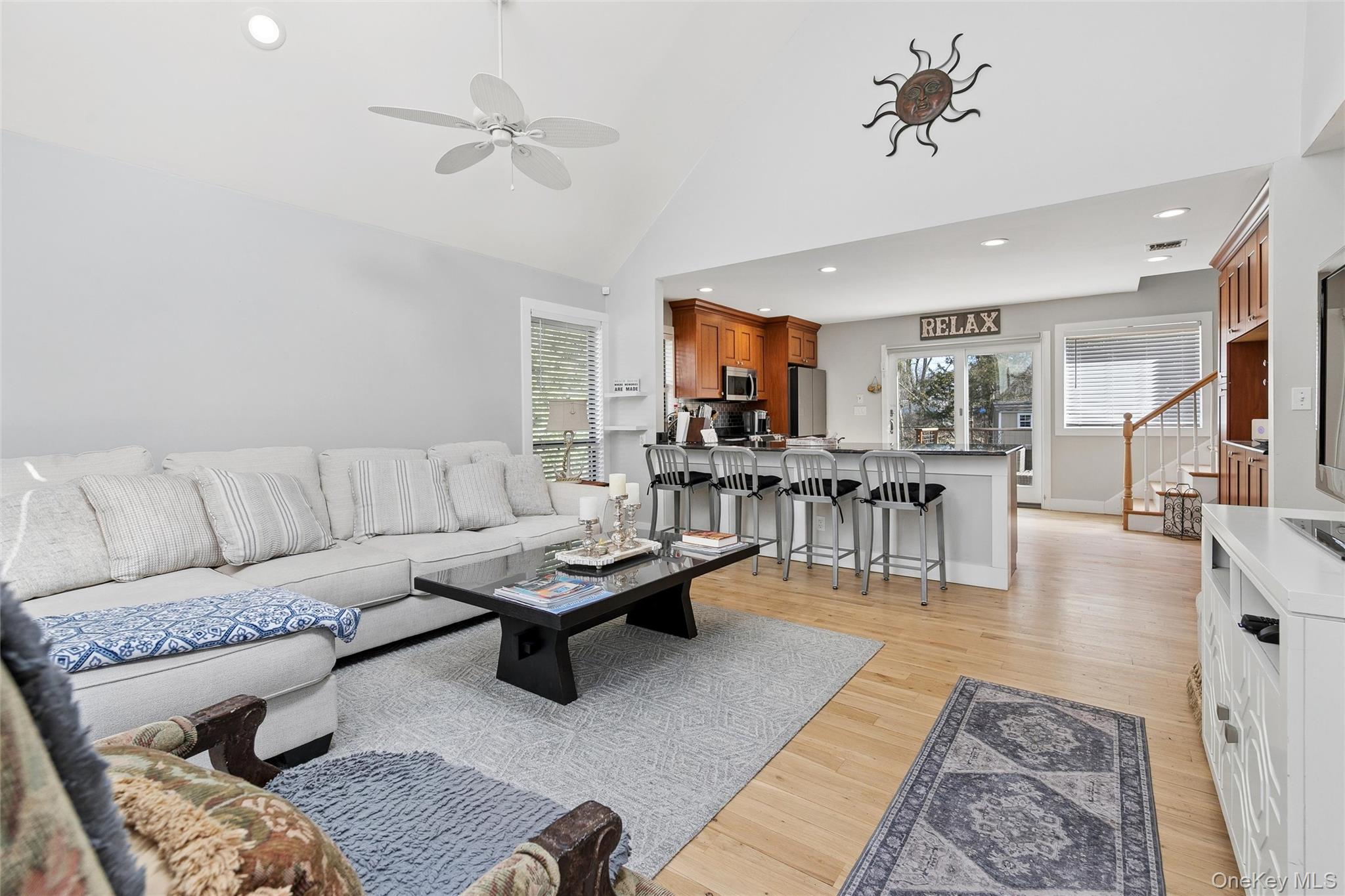 131 Lewis Road East Quogue, NY 11942 - Photo 6 of 25 a living room with furniture and kitchen view