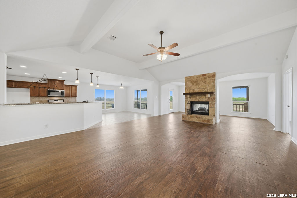 12897 La Vernia Road St. Hedwig, TX 78152 - Photo 7 of 34 a view of a kitchen with a stove cabinets a ceiling fan and wooden floor