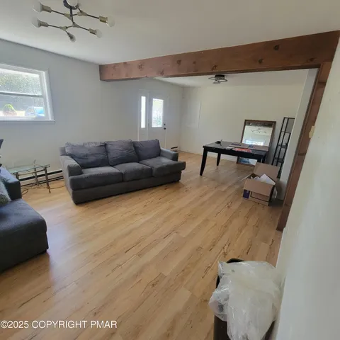 a living room with furniture and a gym machine