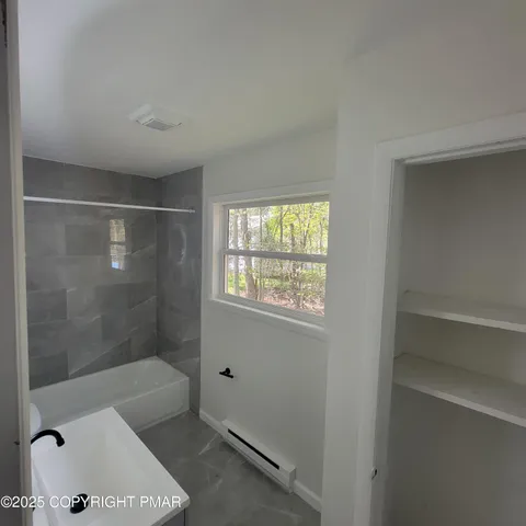 a bathroom with a bathtub and a shower