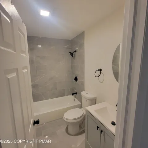 a bathroom with a toilet a sink and a bathtub