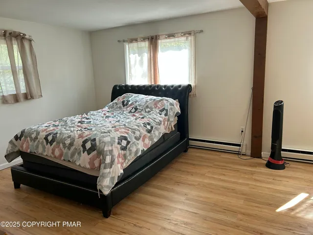 a bed sitting in a bedroom next to a window