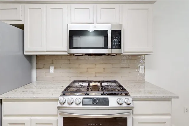 a stove top oven sitting inside of a kitchen